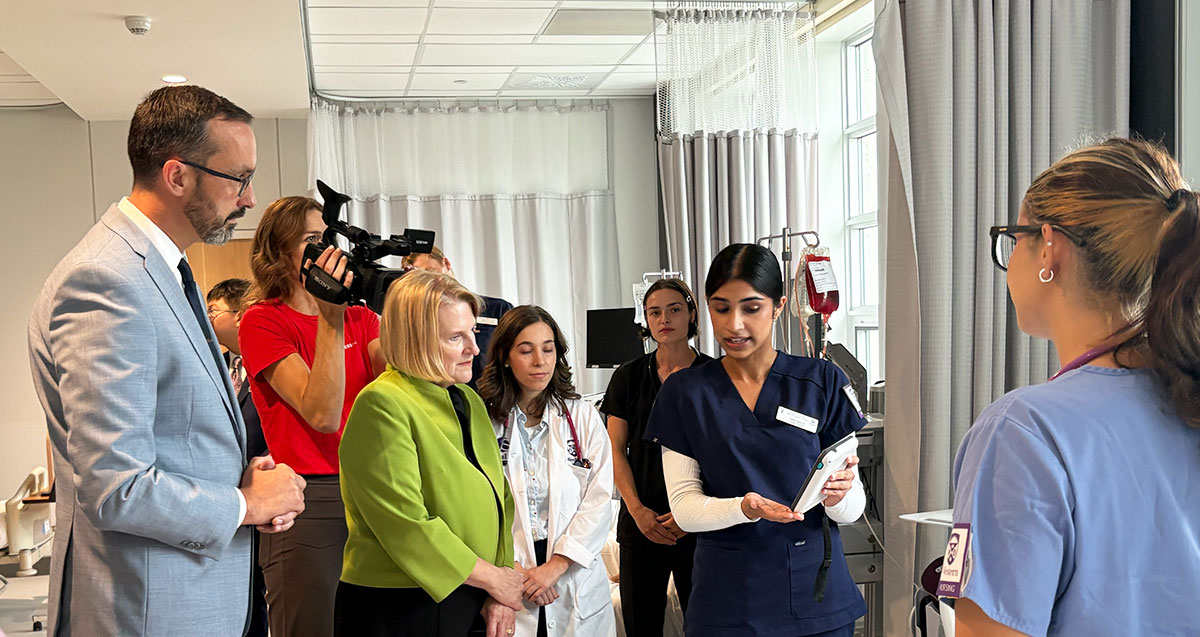Ministers Jones and Quinn talk with nursing students in a clinical skills lab